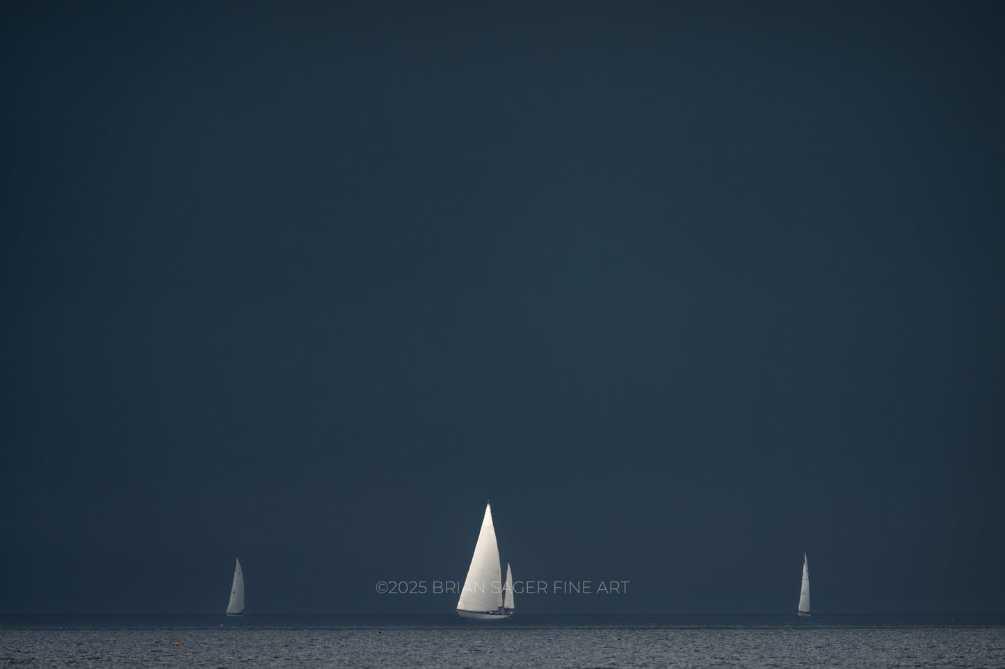 Classic sailboats racing beneath a dark storm sky during the Castine to Camden Race nautical fine art photograph