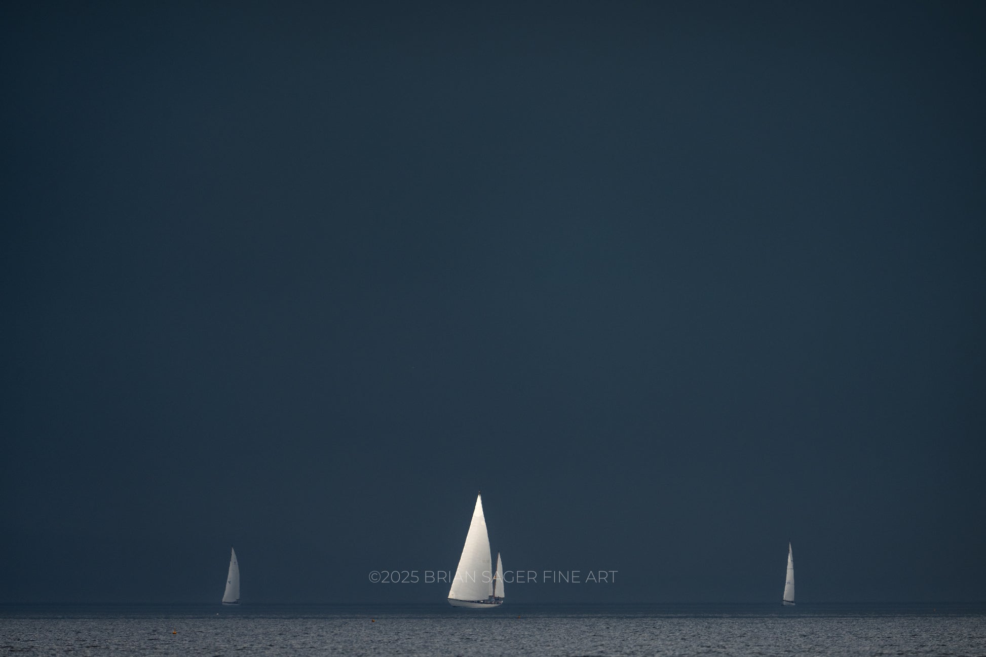 Classic sailboats racing beneath a dark storm sky during the Castine to Camden Race nautical fine art photograph